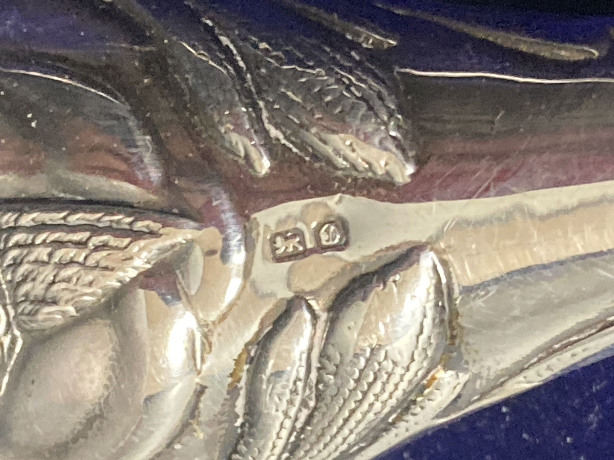 A cased silver handled button hook and shoe horn, a silver and enamel hand mirror, a silver bangle and small silver model ship